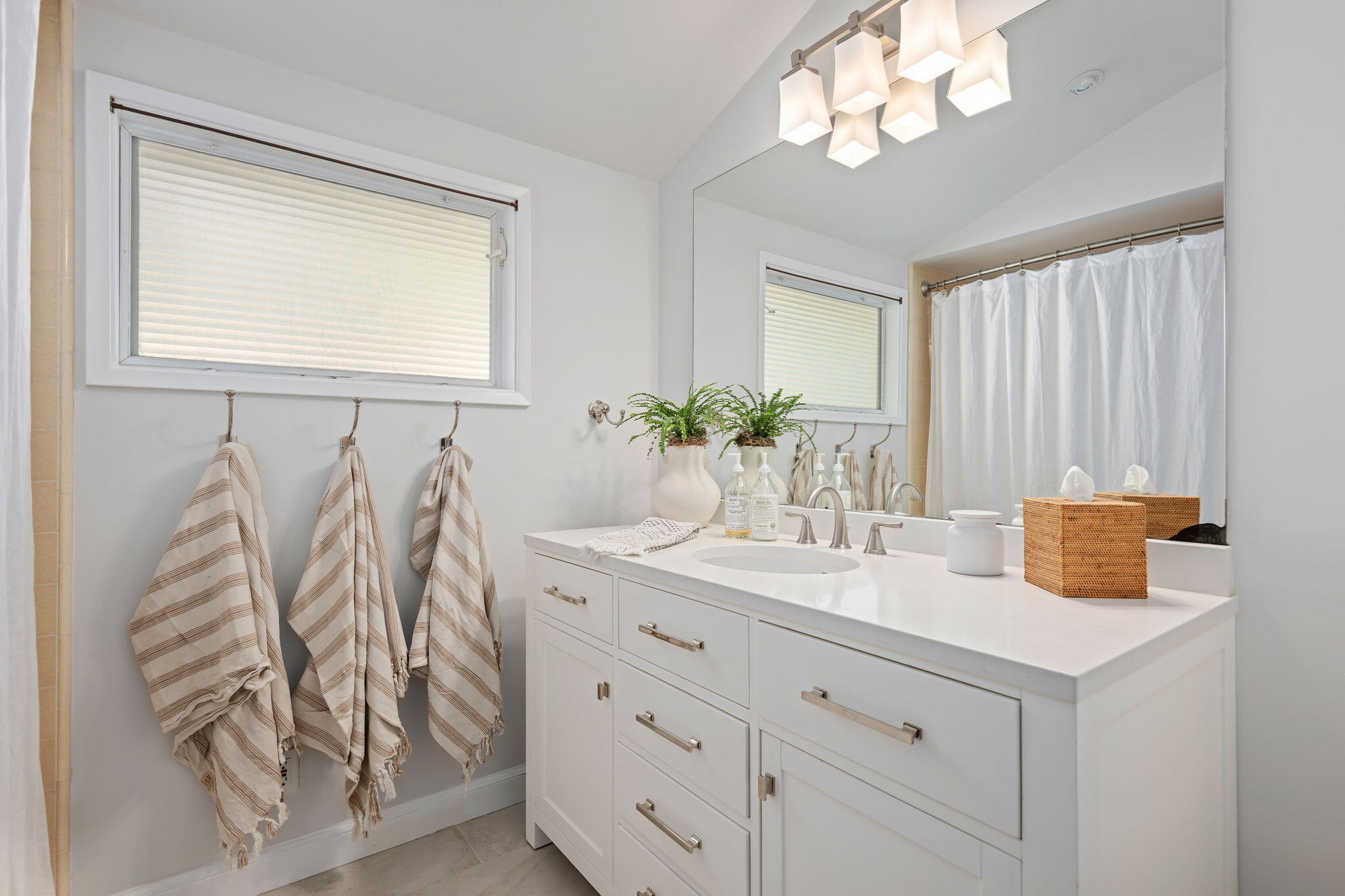 712 Arbolado Road Santa Barbara, CA 93103 - Photo 24 of 28 a bathroom with a granite countertop sink and a mirror