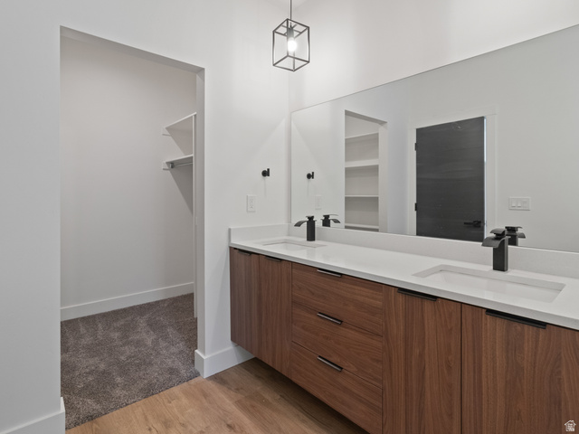 130 East 7085th South, Unit 3 Midvale, UT 84047 - Photo 17 of 30 Full bathroom with double vanity, light wood finished floors, and a walk in closet
