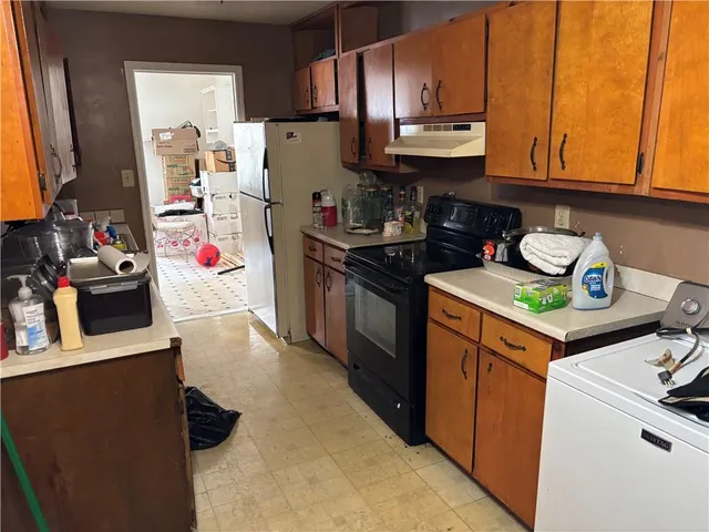 a kitchen with stainless steel appliances granite countertop a refrigerator stove and sink