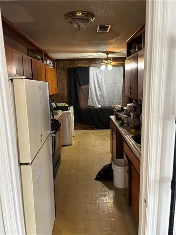 a kitchen with a refrigerator and a washer
