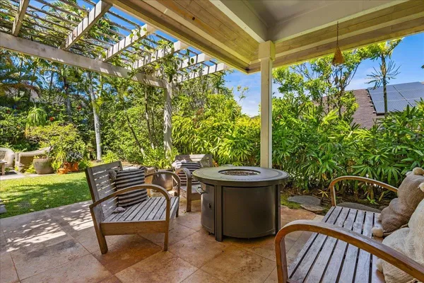 a view of a patio with table and chairs and potted plants