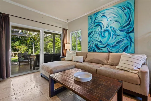a living room with furniture and a floor to ceiling window