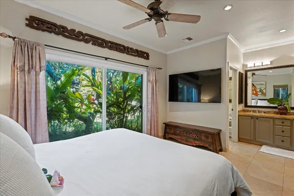 a bedroom with a large bed and a flat tv screen