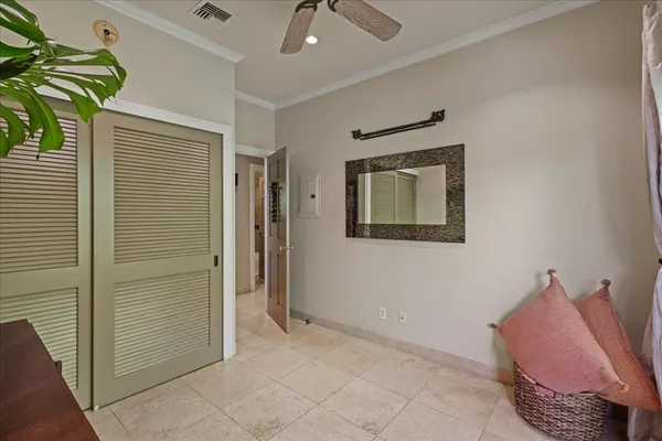a hallway with a couch and a potted plant
