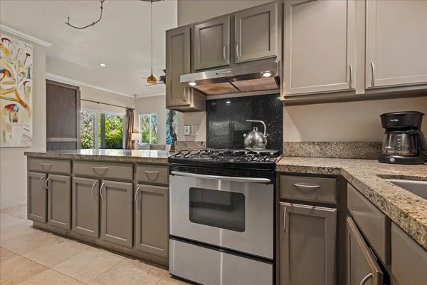 a kitchen with stainless steel appliances granite countertop a sink and cabinets