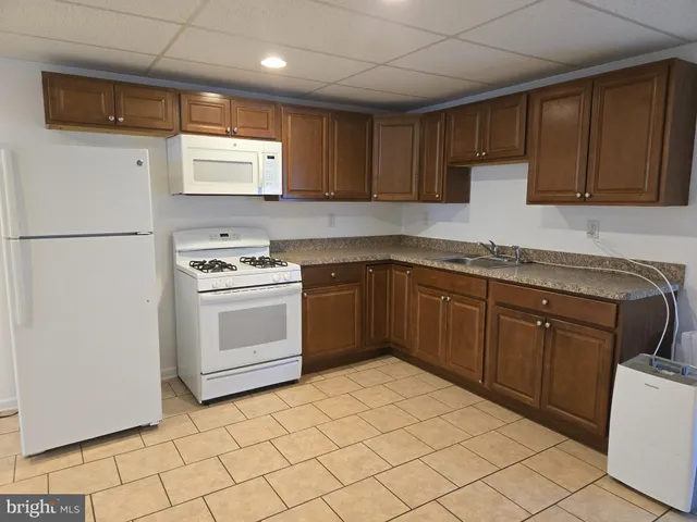 a kitchen with a stove sink and cabinets