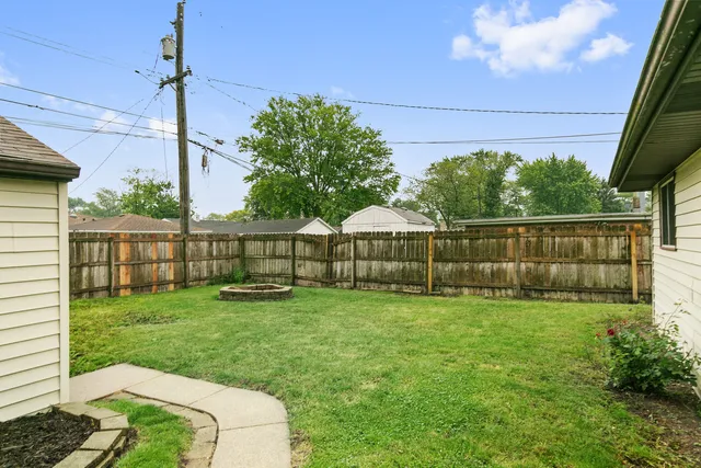 a view of a backyard with a garden and entertaining space
