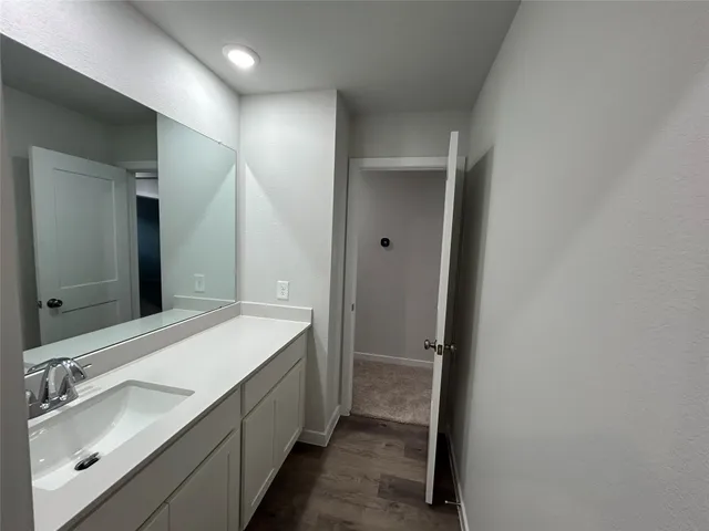a bathroom with a double vanity sink and mirror