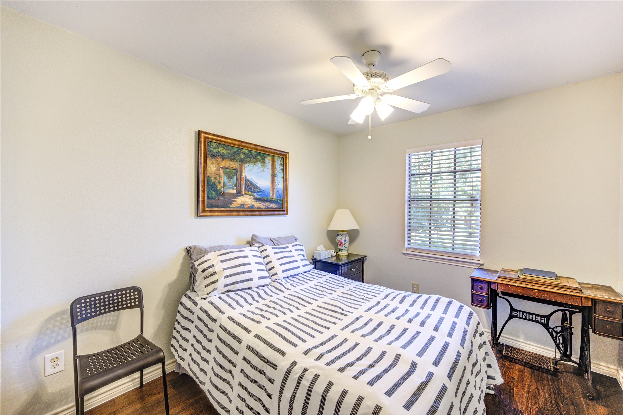 7861 Champion Pines Drive Spring, TX 77379 - Photo 21 of 34 a bedroom with a bed and a chandelier