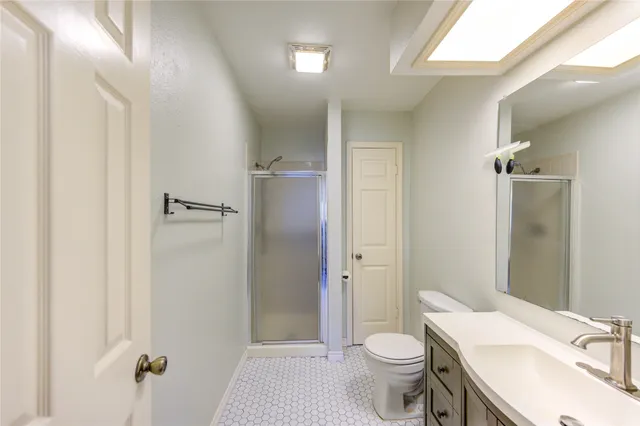 a bathroom with a sink toilet and shower