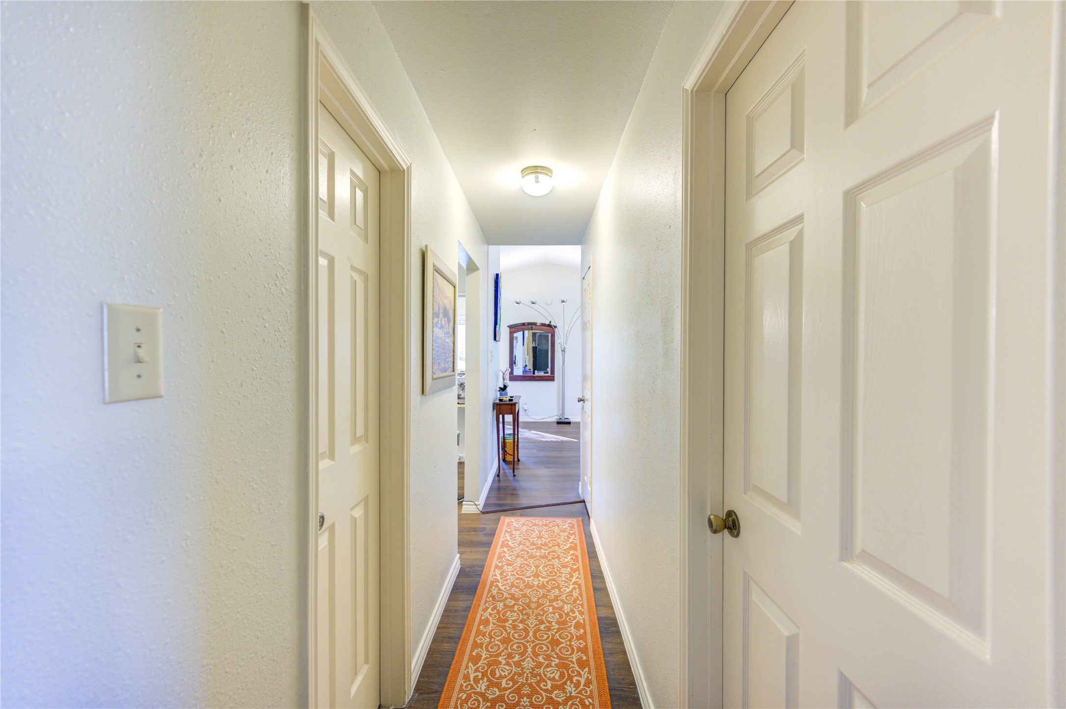7861 Champion Pines Drive Spring, TX 77379 - Photo 29 of 34 a view of a hallway with a livingroom and a bathroom with sink