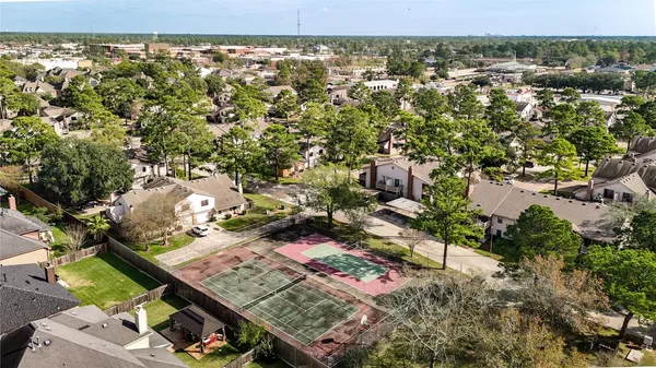 an aerial view of a residential houses with outdoor space