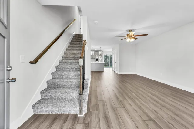 a view of entryway and hall with wooden floor