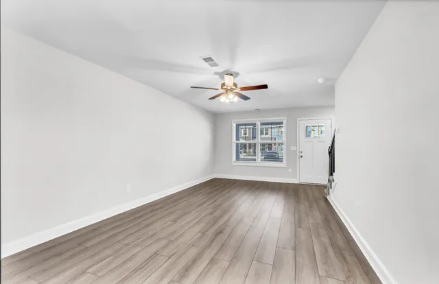 wooden floor in an empty room with a window