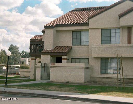 700 East Mesquite Circle, Unit K104 Tempe, AZ 85288 - Photo 1 of 1 a front view of a house with a garden