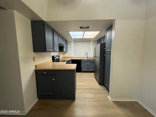 a kitchen with a sink and a refrigerator
