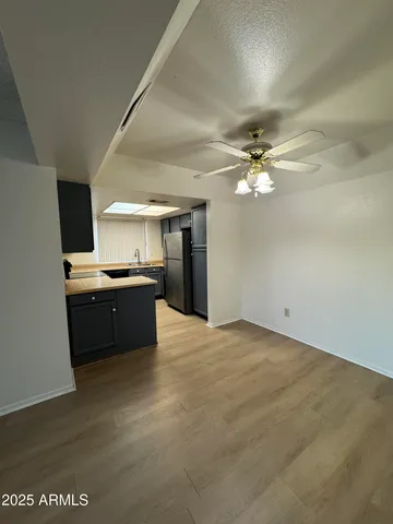a view of a kitchen with a sink and a stove top oven