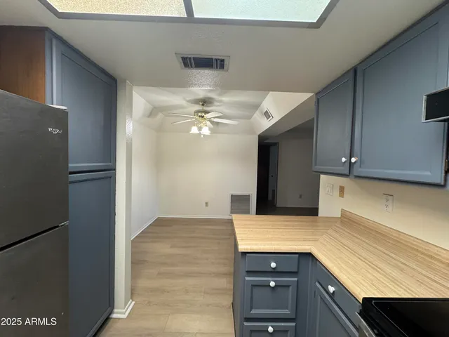a kitchen with a sink and refrigerator