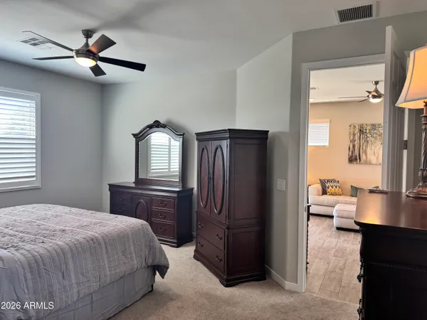 a bedroom with a bed and a chandelier