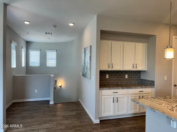 a kitchen with stainless steel appliances granite countertop a sink refrigerator and cabinets