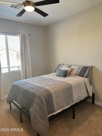 a bedroom with a bed and window