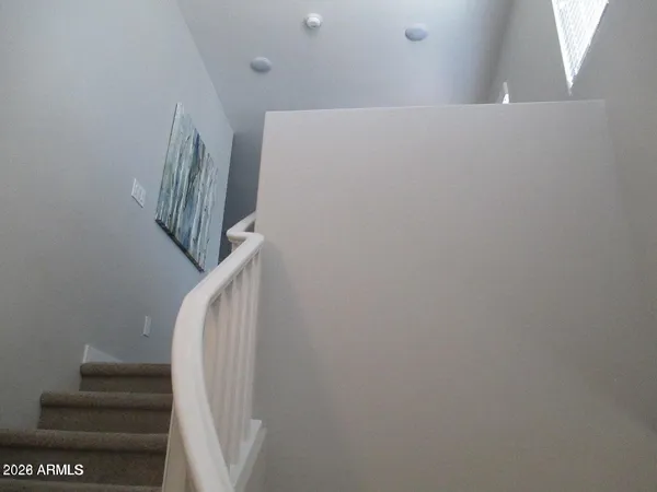 a view of staircase with rug