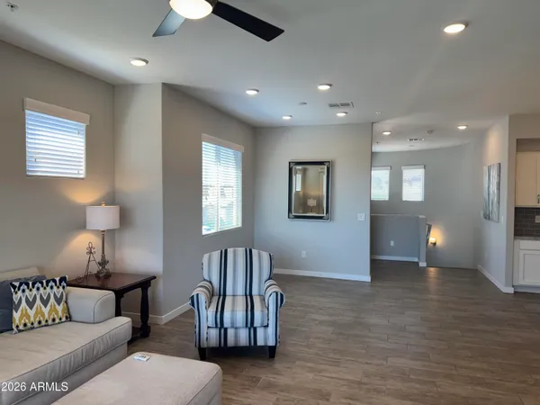 a living room with furniture and a wooden floor