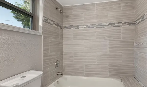 a bathroom with a shower and a toilet