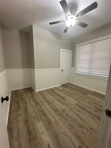 a view of a livingroom with a ceiling fan and window