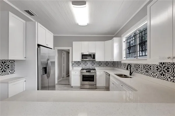a kitchen with a refrigerator and a sink