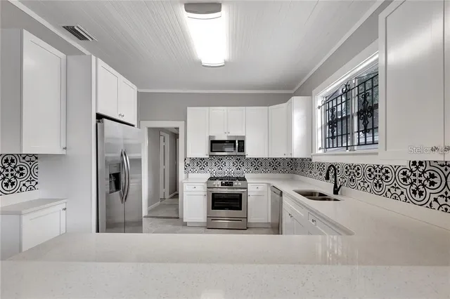 a kitchen with a refrigerator and a sink