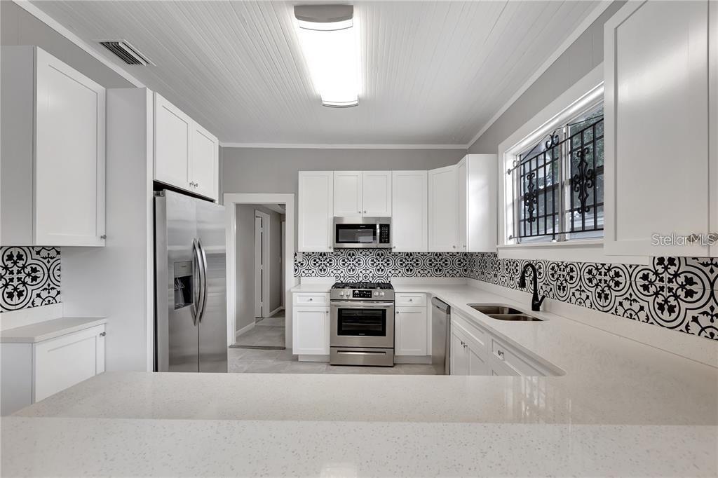 2523 West Spruce Street Tampa, FL 33607 - Photo 3 of 15 a kitchen with a refrigerator and a sink