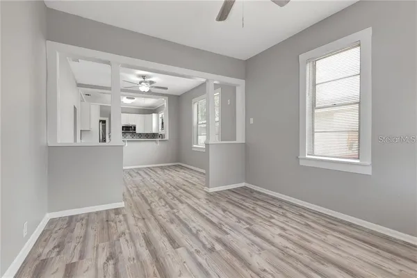 wooden floor in an empty room with a window