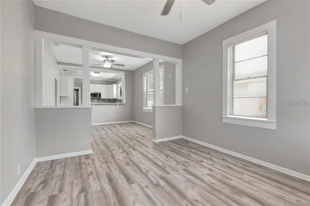 wooden floor in an empty room with a window