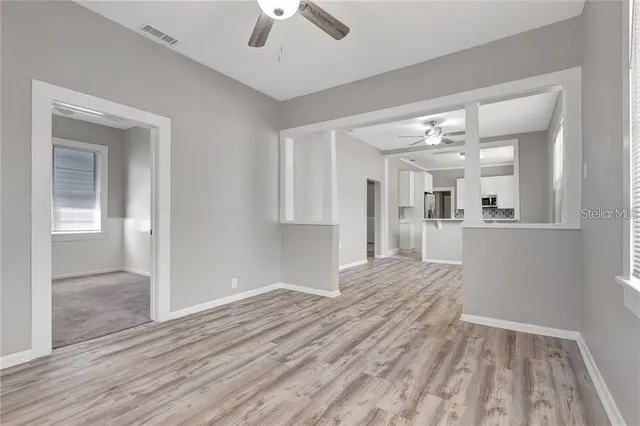 a view of a kitchen with wooden floor and a kitchen