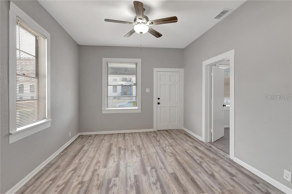 2523 West Spruce Street Tampa, FL 33607 - Photo 8 of 15 a view of empty room with wooden floor and fan
