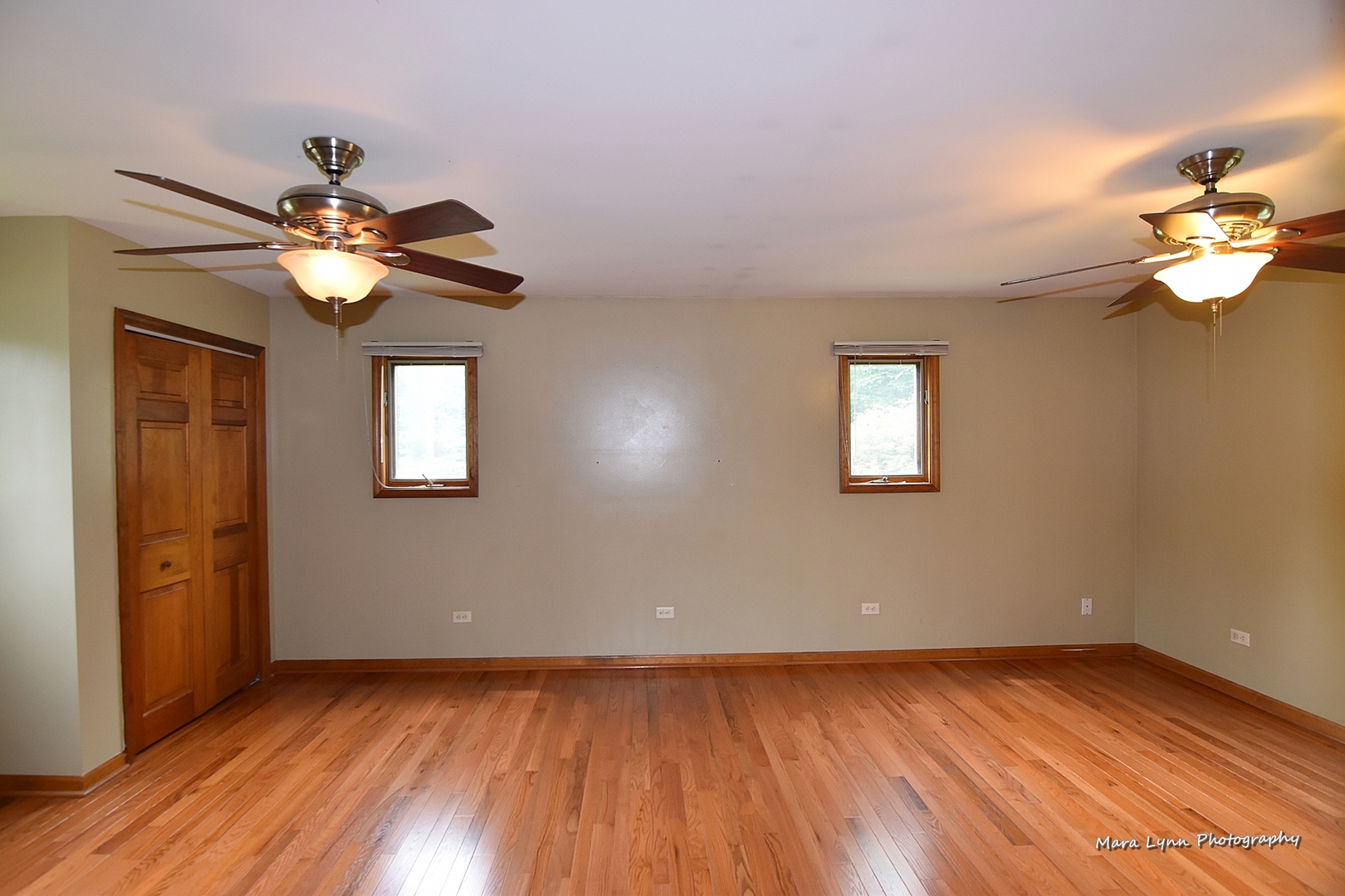 1424 Sunset Road Geneva, IL 60134 - Photo 12 of 38 a view of an empty room with chandelier fan and wooden floor