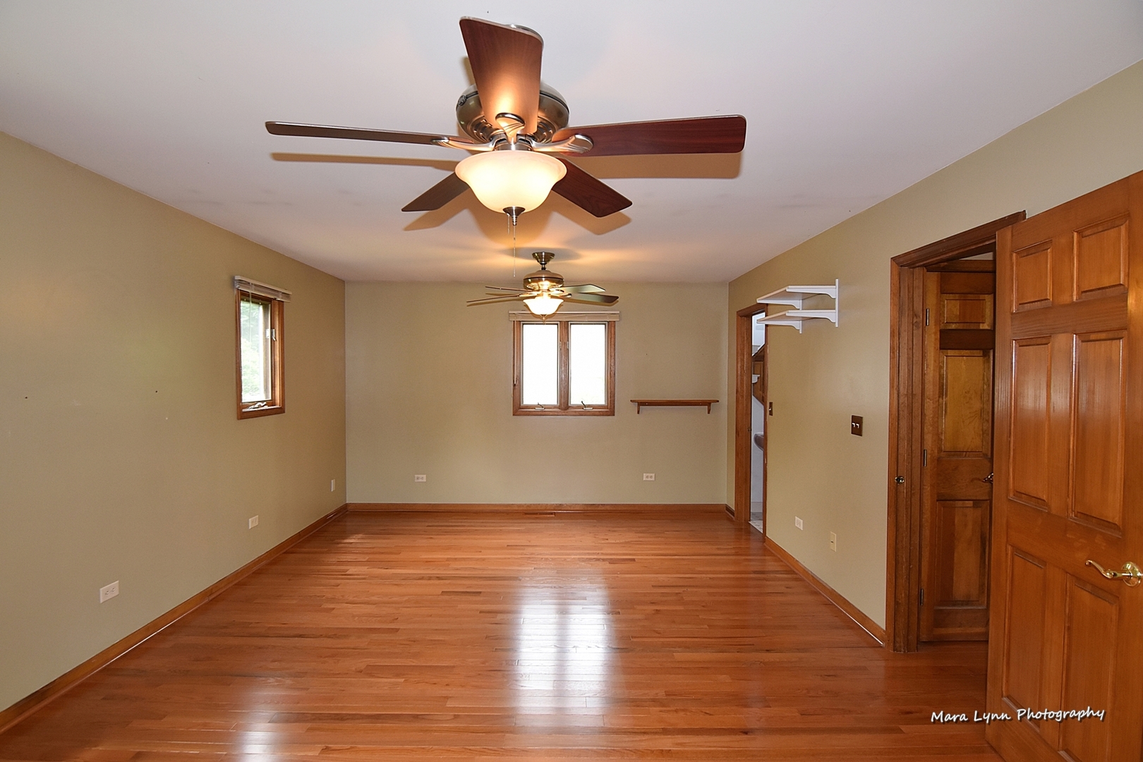 1424 Sunset Road Geneva, IL 60134 - Photo 14 of 38 a view of an empty room with wooden floor and a ceiling fan