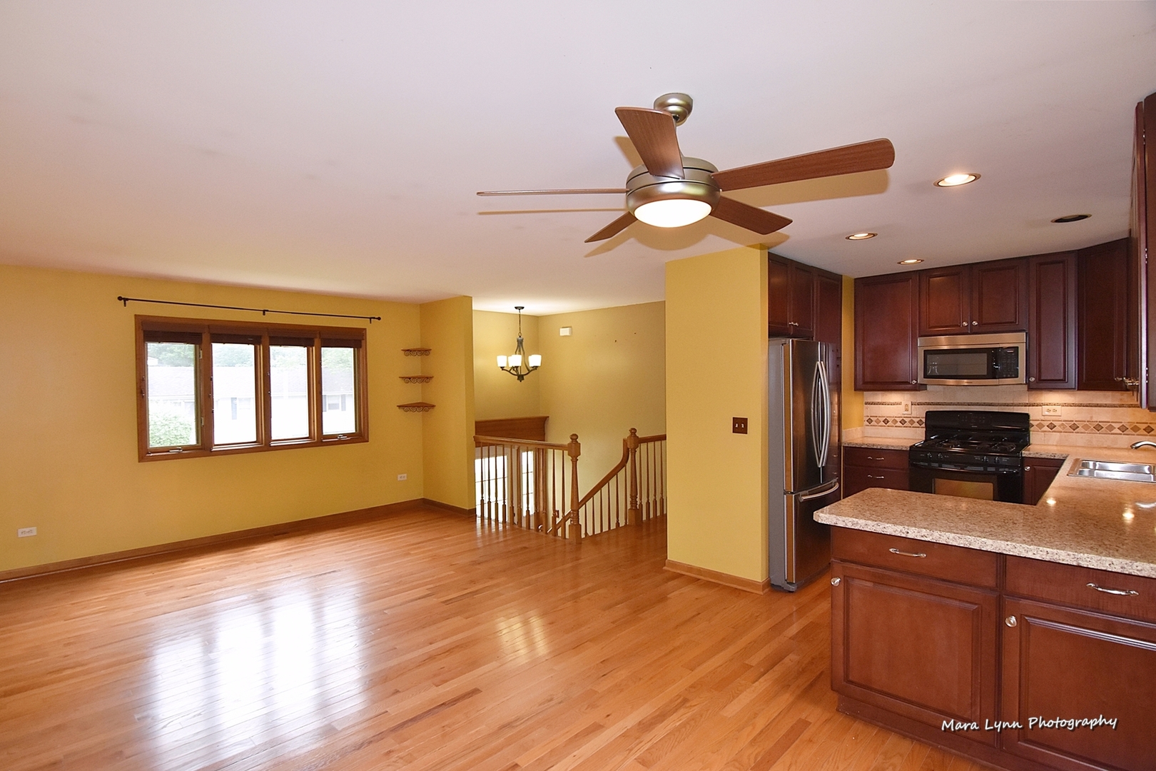 1424 Sunset Road Geneva, IL 60134 - Photo 3 of 38 a kitchen with stainless steel appliances granite countertop a refrigerator a stove top oven a sink with wooden floor and cabinets