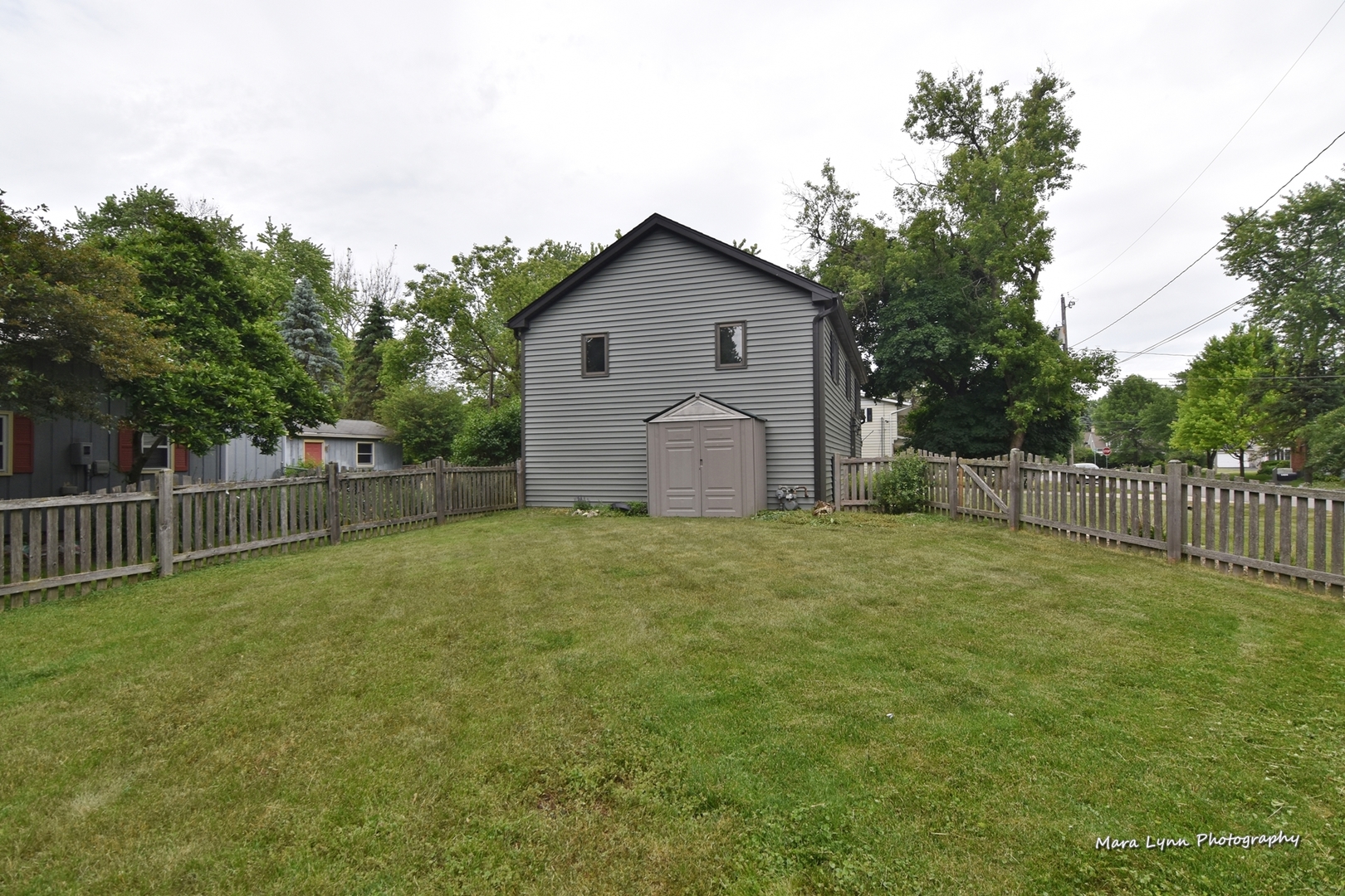 1424 Sunset Road Geneva, IL 60134 - Photo 35 of 38 a backyard of a house with lots of green space and trampoline