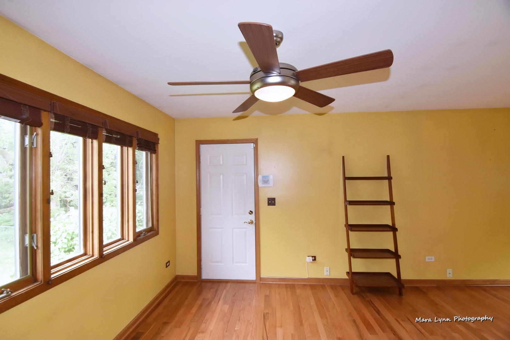 1424 Sunset Road Geneva, IL 60134 - Photo 9 of 38 a view of an empty room with wooden floor and a window