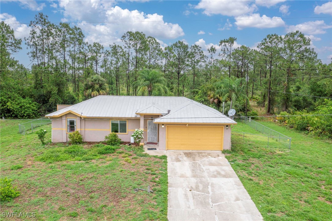 503 East 13th Street Lehigh Acres, FL 33972 - Photo 1 of 15 a aerial view of a house next to a big yard and large trees