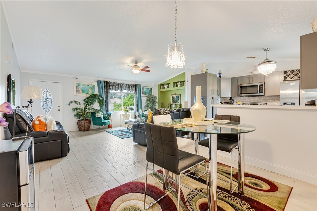 503 East 13th Street Lehigh Acres, FL 33972 - Photo 7 of 15 a living room with furniture a table and chairs