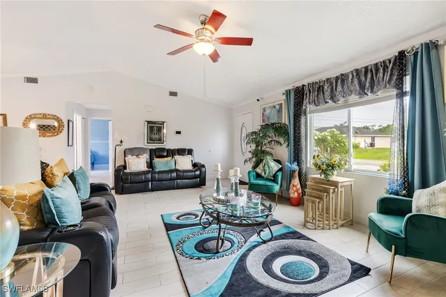 a living room with furniture a rug and a large window