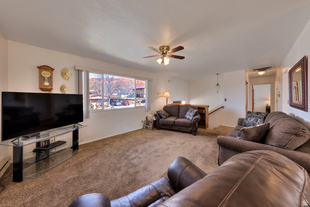 738 Locust Lane Moab, UT 84532 - Photo 5 of 25 Living area featuring carpet floors and a ceiling fan