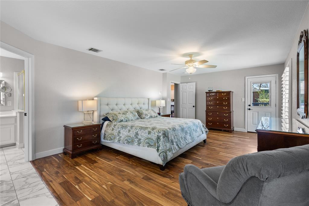 1007 Santa Fe Street Denton, TX 76205 - Photo 16 of 37 Bedroom featuring dark wood-style flooring, ceiling fan, and ensuite bathroom