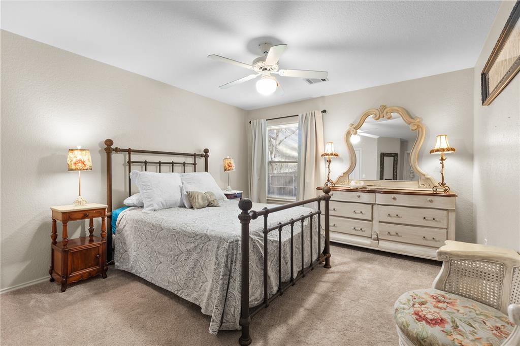 1007 Santa Fe Street Denton, TX 76205 - Photo 21 of 37 Carpeted bedroom featuring ceiling fan and a textured wall