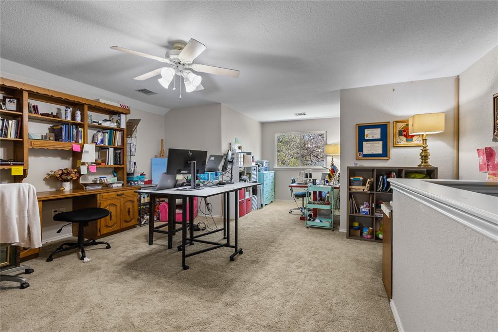 1007 Santa Fe Street Denton, TX 76205 - Photo 25 of 37 Office space with light colored carpet, a ceiling fan, and a textured ceiling/craft room - this is the only room upstairs