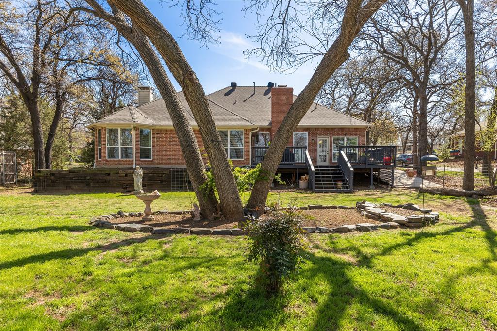 1007 Santa Fe Street Denton, TX 76205 - Photo 30 of 37 Rear view of property with a chimney, brick siding, and a lawn