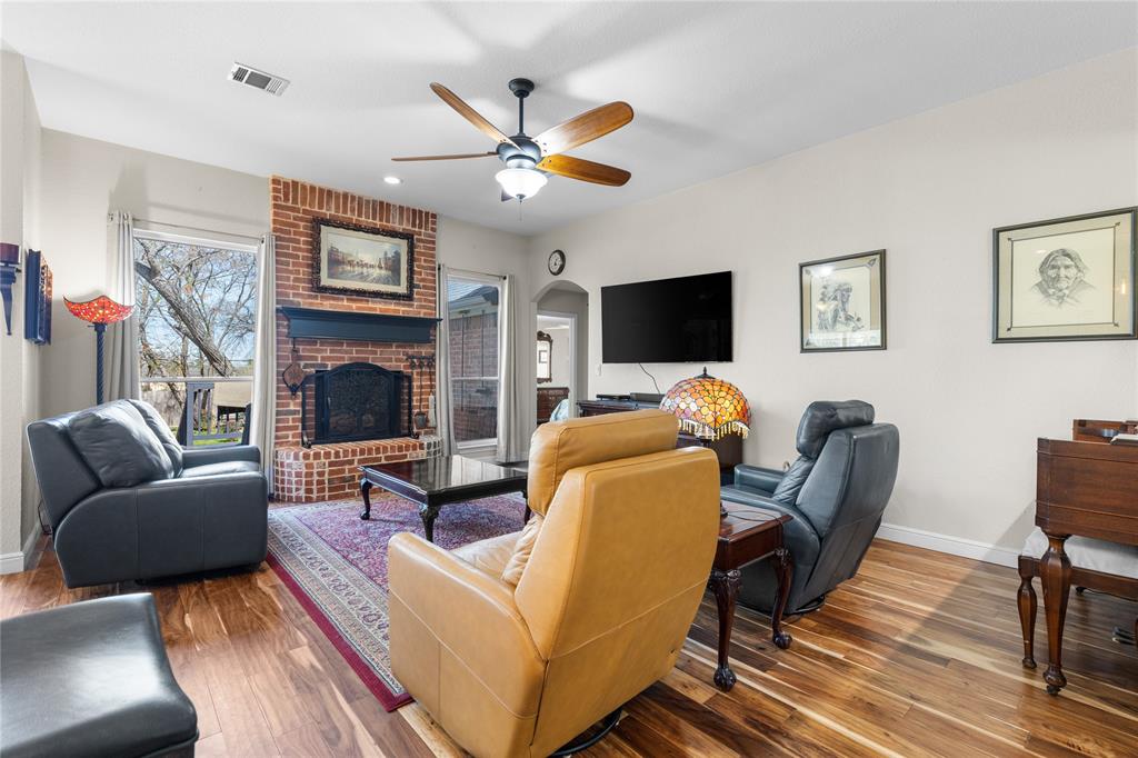 1007 Santa Fe Street Denton, TX 76205 - Photo 7 of 37 Living room with wood finished floors, a brick fireplace, and plenty of natural light